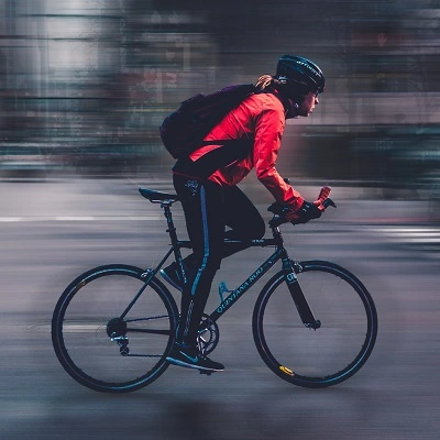 Woman on a road bike in a city, going fast